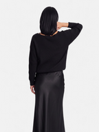 Women's black satin skirt and sweater set back shot
