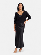 Women's black satin skirt and sweater set full body shot