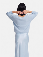 Women's light blue satin skirt and sweater set back shot