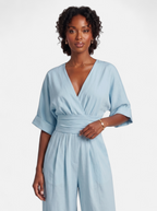 Women's sky blue wrap v-neck jumpsuit hero shot
