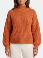 Women's orange oversized turtleneck sweater detail shot