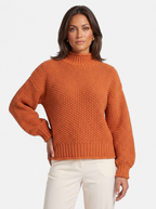 Women's orange oversized turtleneck sweater hero shot