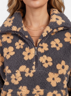 Women's yellow floral fleece half-zip jacket detail shot