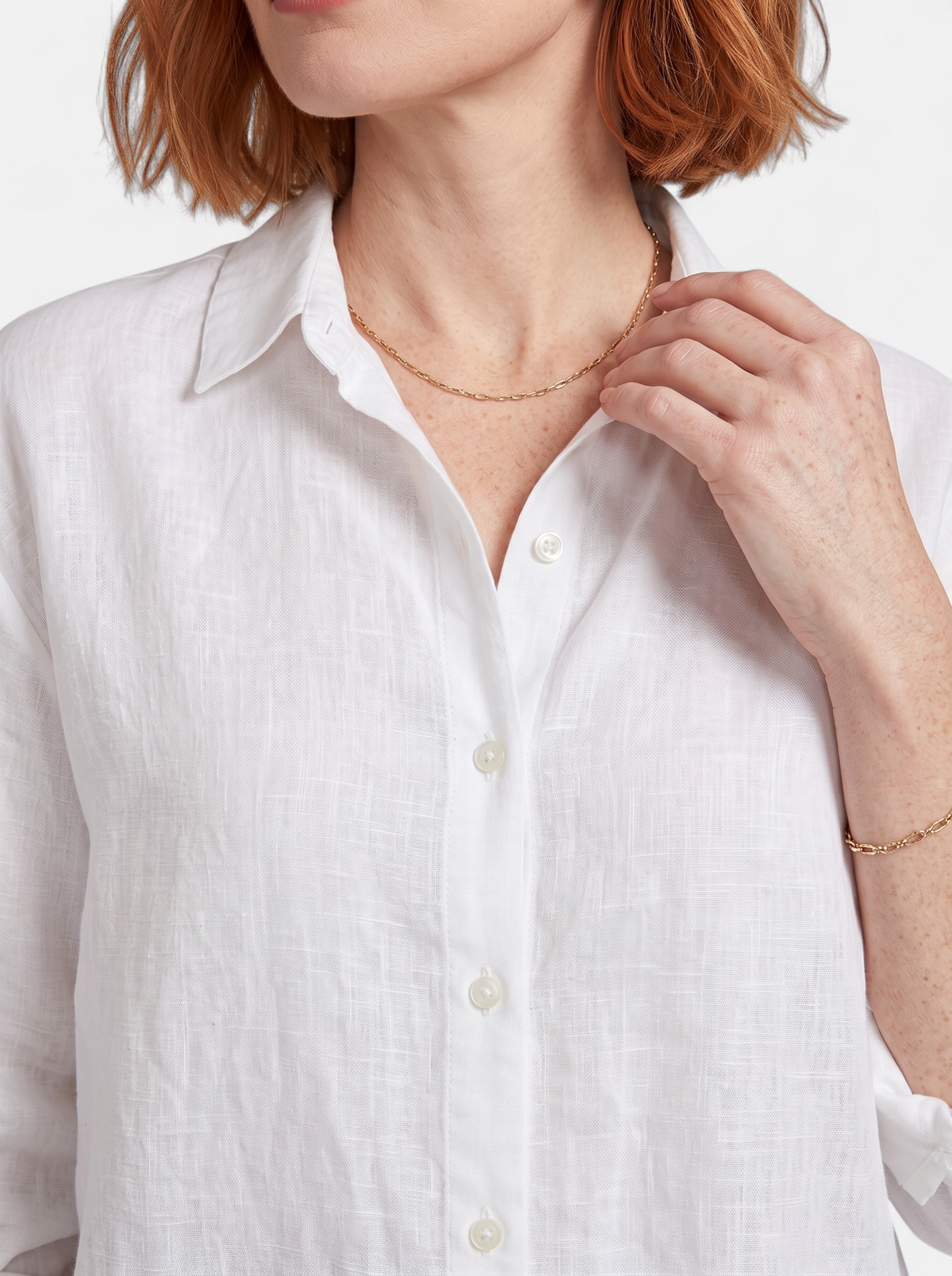Women's white oversized linen button-up shirt detail shot